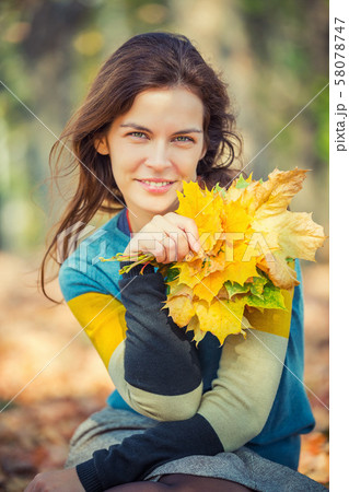 Portrait of young beautiful woman in autumn park 58078747