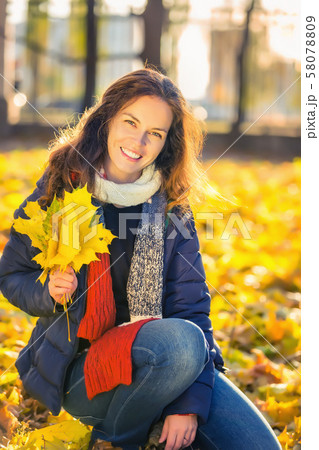Portrait of young beautiful woman in autumn park Portrait of young beautiful woman in autumn park 58078809