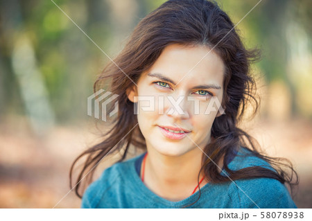 Portrait of young beautiful woman in autumn park 58078938