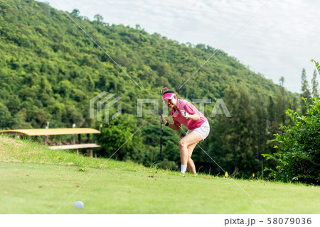 Asian woman golfer action to win  58079036