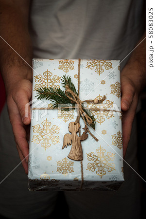 Wrapped New Year's gifts with an angel in his 58083025