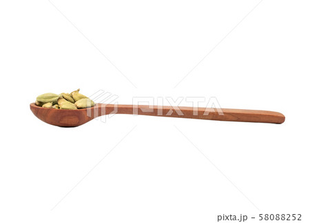 Green cardamom in spoon 58088252