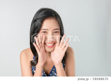 Attractive young asian woman announcing with hands 58088670