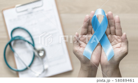 Blue ribbon for prostate cancer awareness and men's health care concept with bow color in doctor support or patient hands Blue ribbon for prostate cancer awareness and men's health care concept with bow color in doctor support or patient hands 58089461