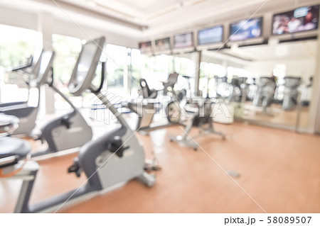 Blur gym background fitness center or health club with blurry sports exercise equipment for aerobic workout and bodybuilding Blur gym background fitness center or health club with blurry sports exercise equipment for aerobic workout and bodybuilding 58089507
