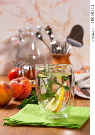 Refreshing drink with lemon and mint in a glass Refreshing drink with lemon and mint in a glass 58090511