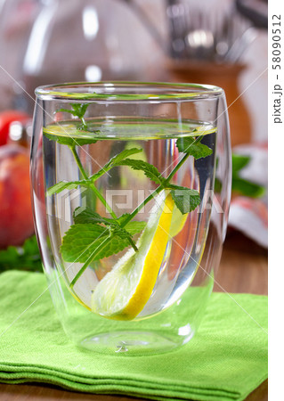 Refreshing drink with lemon and mint in a glass Refreshing drink with lemon and mint in a glass 58090512