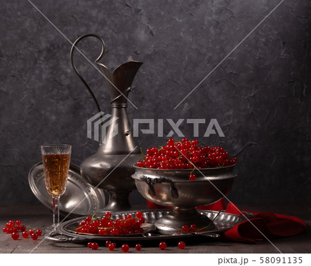 Still life with red currant berries and old pewter 58091135