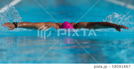 Swim competition swimmer athlete doing butterfly stroke in swimming pool 58091667