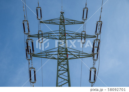 High voltage power lines through fields and meadows they supply power to towns and villages 58092701
