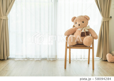 bear doll on chair 58094284