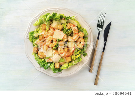 Shrimp Caesar salad with Parmesan cheese, croutons and lettuce, shot from above Shrimp Caesar salad with Parmesan cheese, croutons and lettuce, shot from above 58094641