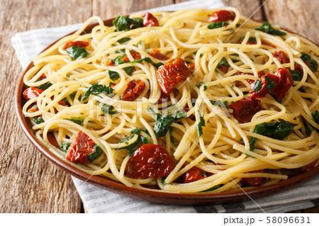 Traditional spaghetti with dried tomatoes, cheese Traditional spaghetti with dried tomatoes, cheese 58096631