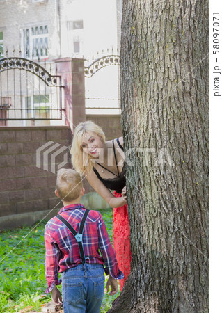 Beautiful happy young family hugs by a tree in the 58097071