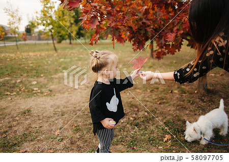 Mom and daughter spend time together in the park in autumn time. Happy family concept 58097705