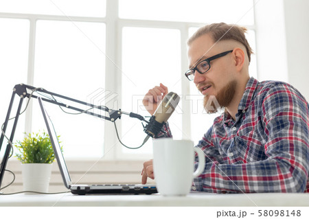 Radio host concept - Close-up of handsome man working as radio host at radio station 58098148
