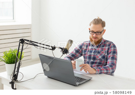 Radio host, streamer and blogger concept - Handsome man working as radio host at radio station 58098149