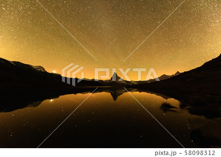 Incredible night view of Stellisee lake with Matterhorn peak in Swiss Alps Incredible night view of Stellisee lake with Matterhorn peak in Swiss Alps 58098312