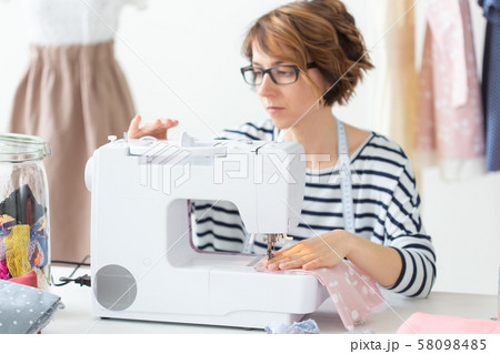 clothing designer, seamstress, people concept - clothing designer working in her studio clothing designer, seamstress, people concept - clothing designer working in her studio 58098485