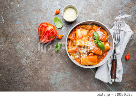 Pasta paccheri with tomato sauce 58099153