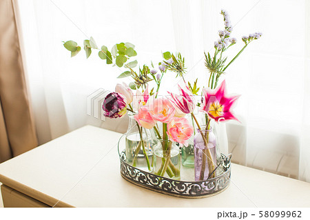 View of bouquets of tulips in glass jars 58099962