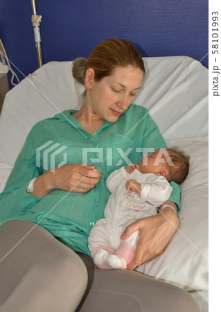 A mother looks at her newborn baby A mother looks at her newborn baby 58101993