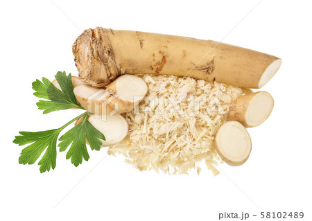 Horseradish root with slices grated pile and parsley isolated on white background 58102489