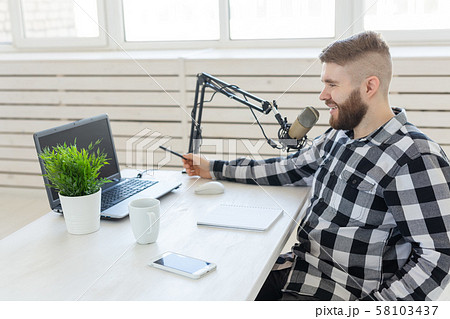 Radio host concept - Side view of handsome man working as radio host at radio station 58103437