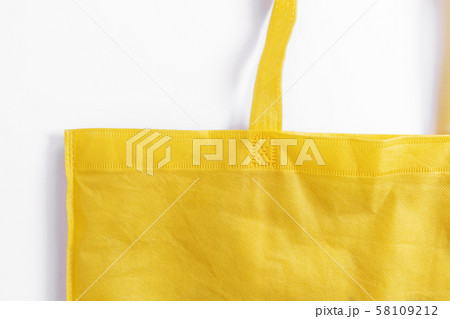 Close-up, Yellow reusable fabric bag, on white background 58109212