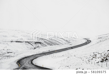 Uphill curve road with side way full of snow in winter Uphill curve road with side way full of snow in winter 58109375
