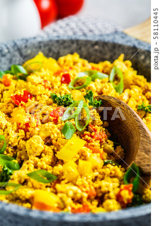 Tofu scramble with vegetables in a pan.  58110445