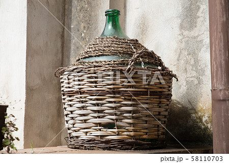 Empty carboy in rustic house 58110703