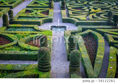 Colorful formal garden at sunset, with a Colorful formal garden at sunset, with a 58112261