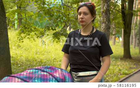 Young attractive women walking with the stroller 58116195