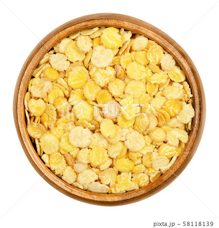 Soya flakes, soy flakes in wooden bowl over white 58118139
