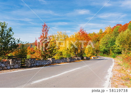 country road in mountains on a sunny day country road in mountains on a sunny day 58119738