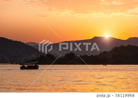 Boat in lake Pichola on sunset. Udaipur, Rajasthan, India 58119968