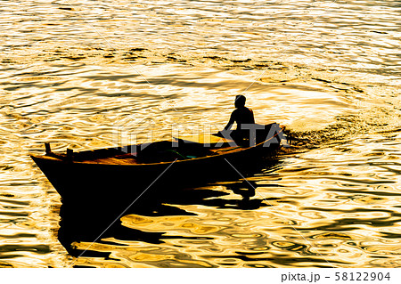 boatman sailing on his wooden boat 58122904