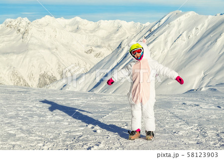 Cute adorable preschooler caucasian kid girl portrait with ski in helmet, goggles and unicorn fun 58123903