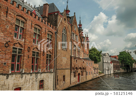 Old brick buildings on canal of Bruges Old brick buildings on canal of Bruges 58125146