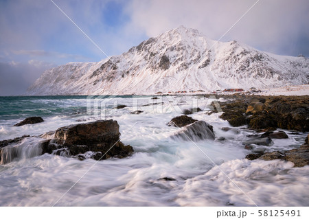 Coast of Norwegian sea on rocky coast in fjord on sunset Coast of Norwegian sea on rocky coast in fjord on sunset 58125491