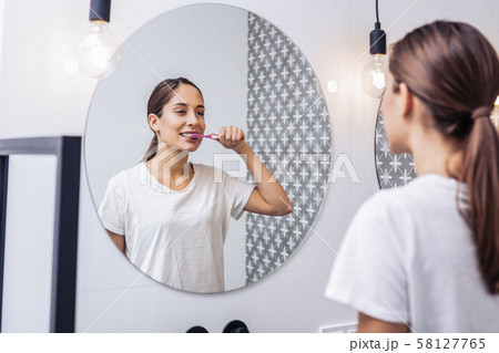 Young woman preparing for going to bed Young woman preparing for going to bed 58127765