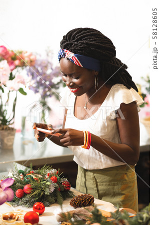 Positive delighted young woman taking picture on her gadget 58128605