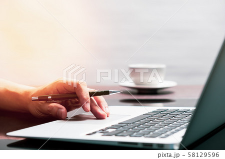 man using laptop computer working on new project idea at desk in office man using laptop computer working on new project idea at desk in office 58129596