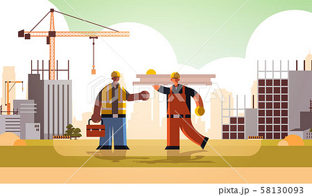 carpenter holding planks discussing with african american engineer workmen in uniform standing 58130093