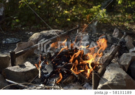 Bonfire, coal and stones in the forest. 58131189