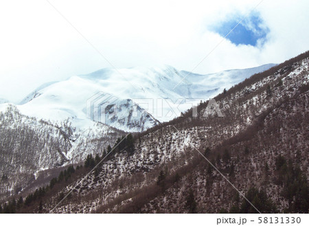 Mountain landscape of Svaneti with cloudy sky and fog Mountain landscape of Svaneti with cloudy sky and fog 58131330