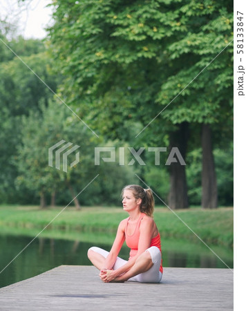 Woman Doing Yoga in the Park Woman Doing Yoga in the Park 58133847