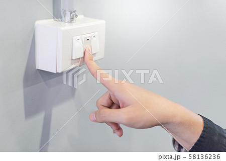 Male hand turning off the light. Energy saving 58136236