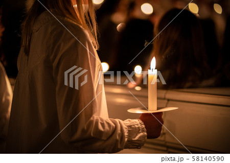 People handling candles in the hands. Christmas and lucia holidays 58140590